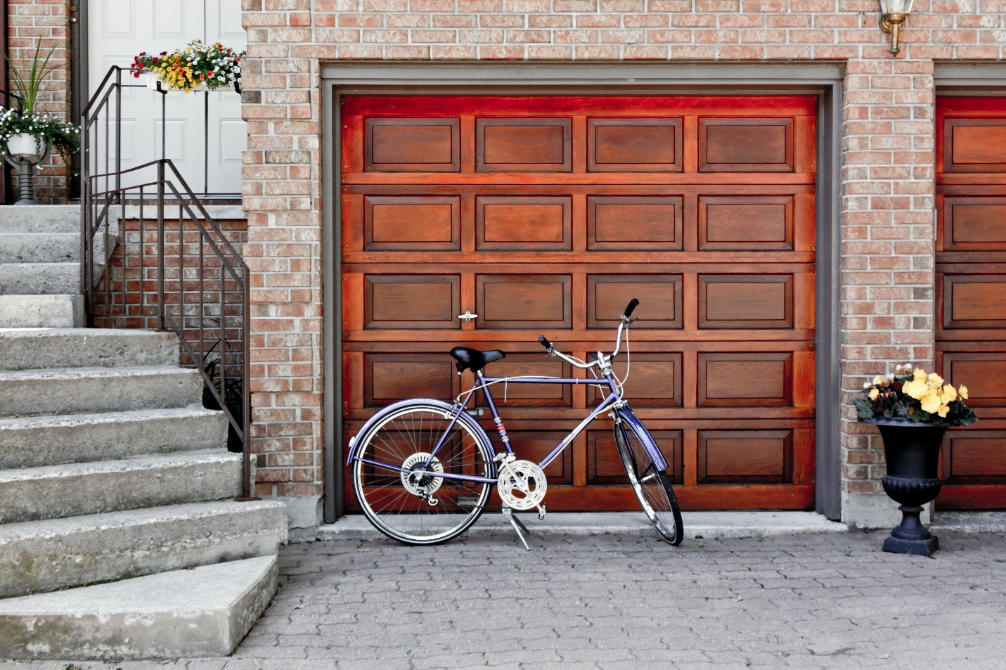Cycle In Front Of a Brown Garage Door